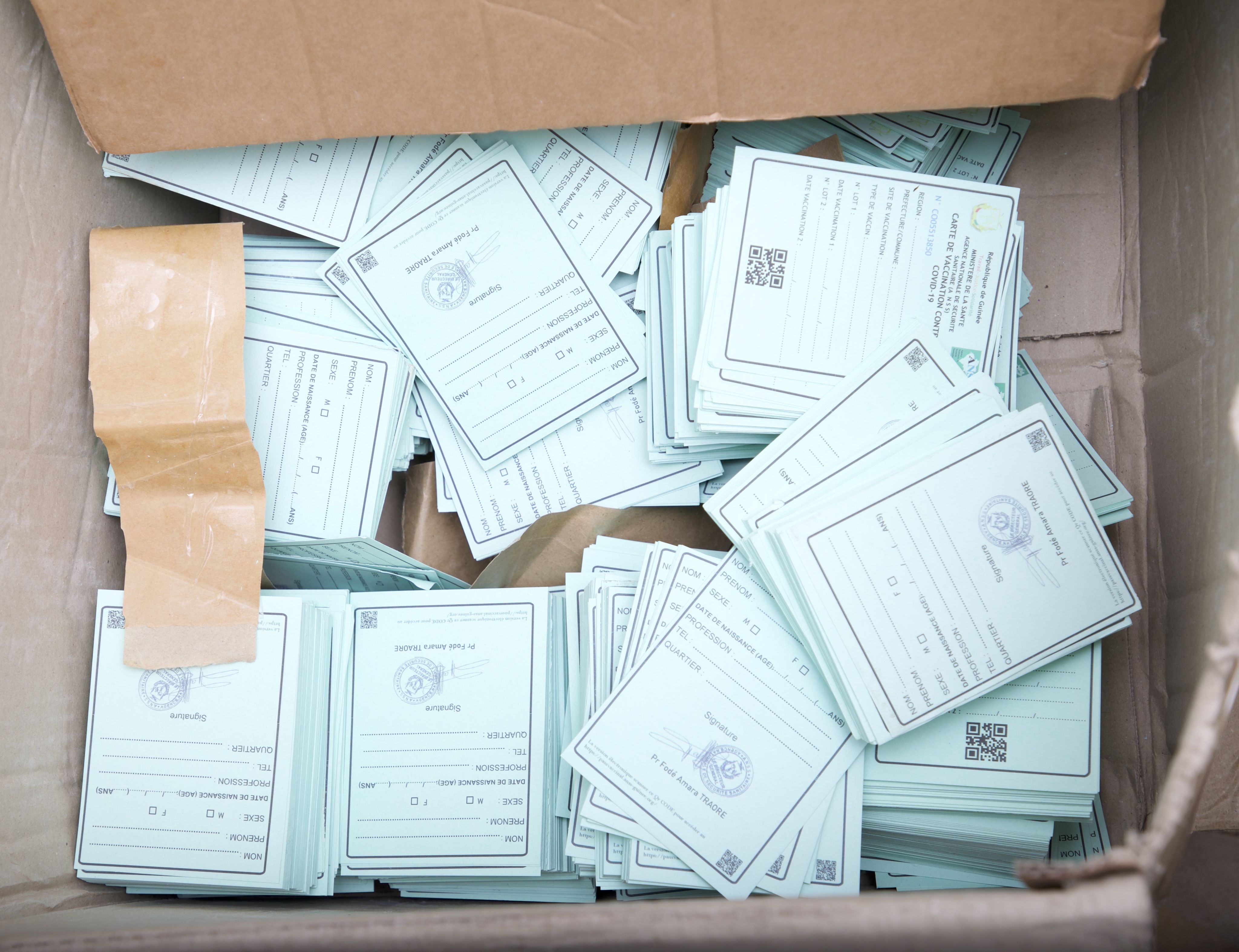 a box full of blue vaccination cards