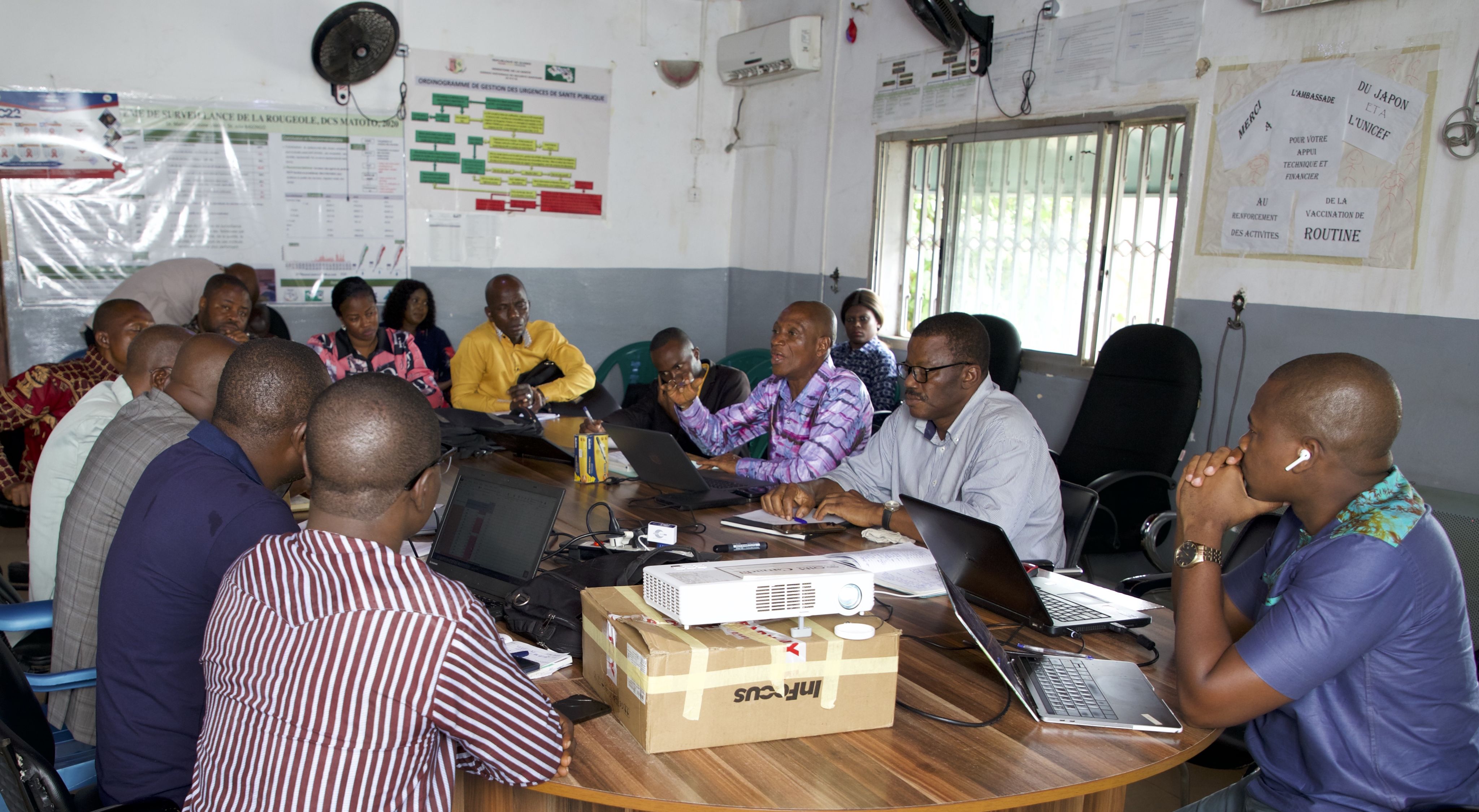 people sitting around a large table in a meeting room