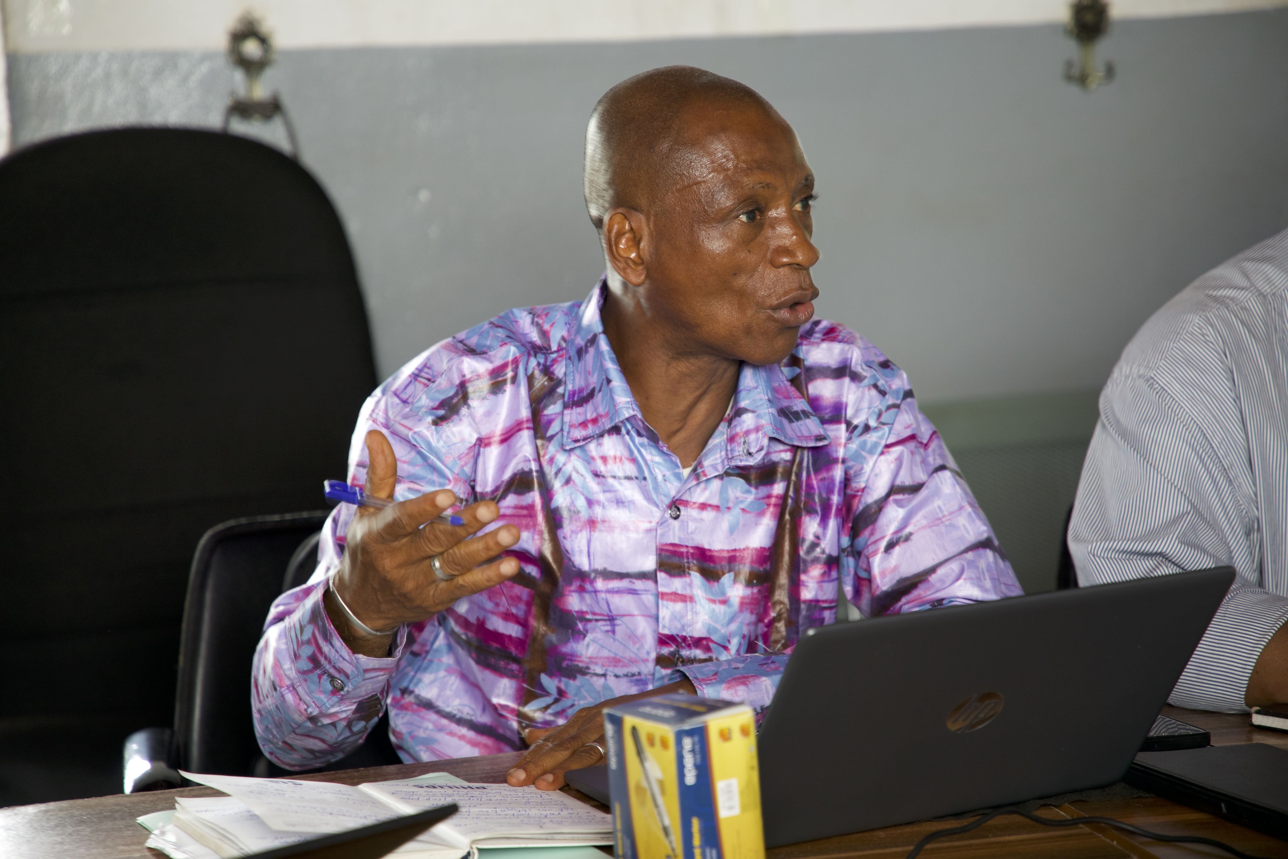man sitting in a meeting room and talking