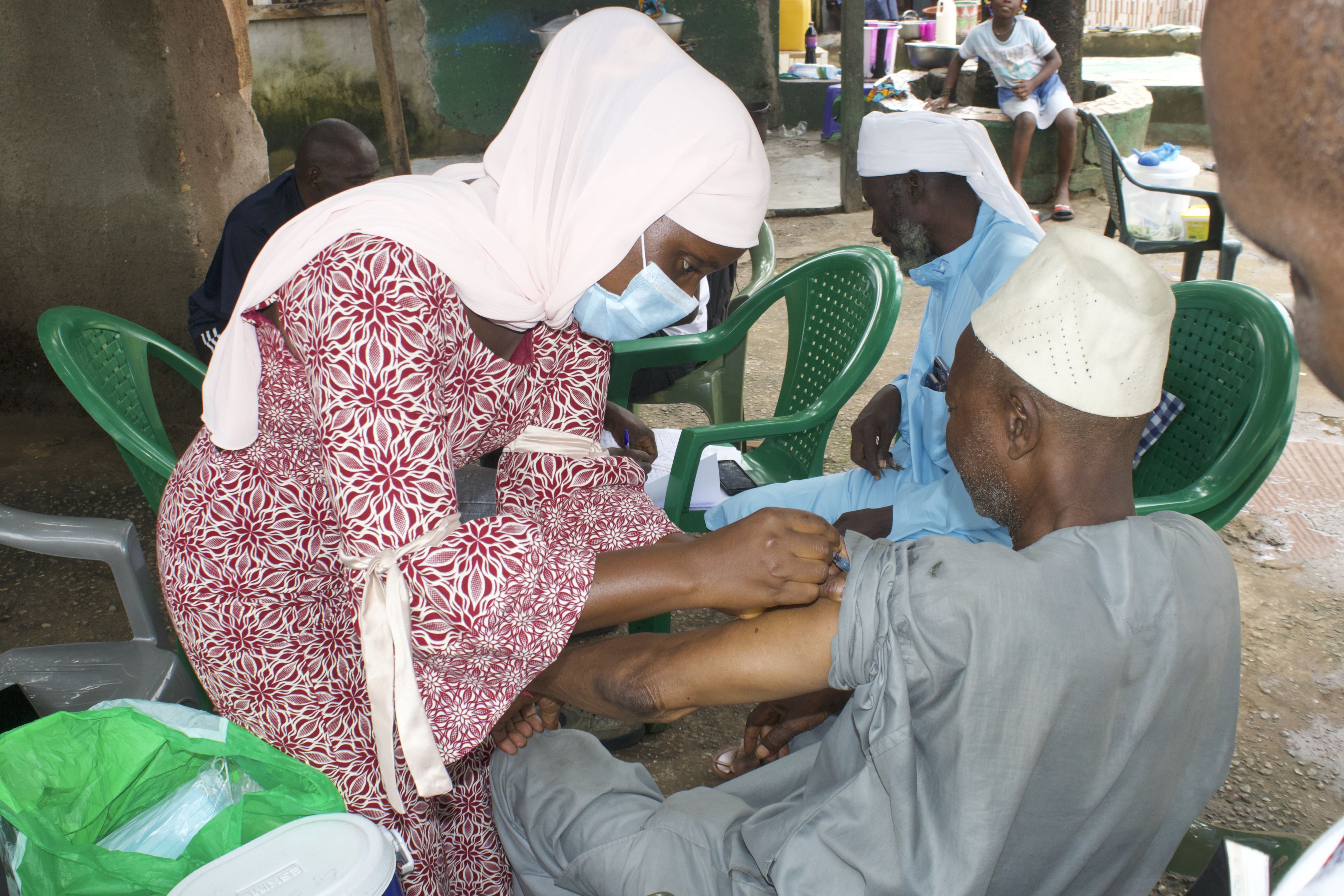 health worker vaccinating a man